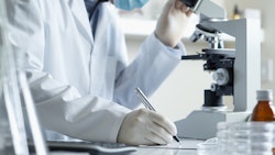 Scientist With Microscope Dreamstime Credit 18percentgrey Resized