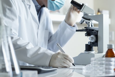 Scientist With Microscope Dreamstime Credit 18percentgrey Resized