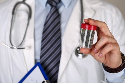 Doctor Holding Medical Marijuana Adobe Stock Credit Megaflopp Resized