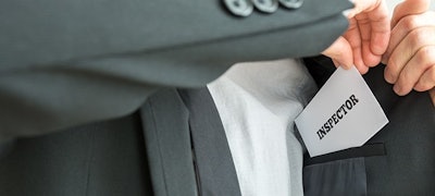 Inspector With Business Card Adobe Stock Credit Gajus Resized