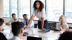 Woman Standing During Meeting Adobe Stock Credit Monkey Business Resized