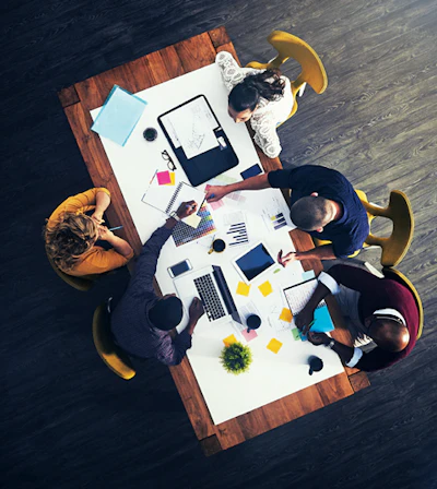 I Stock 912141724 Coworkers Around Business Table Aerial Fmt