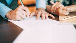 Filling Out Application Form At Table Adobe Stock Credit Mangostar Resized