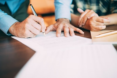 Filling Out Application Form At Table Adobe Stock Credit Mangostar Resized