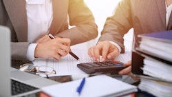 Accountants Using Calculator Adobe Stock Credit Rogerphoto Resized