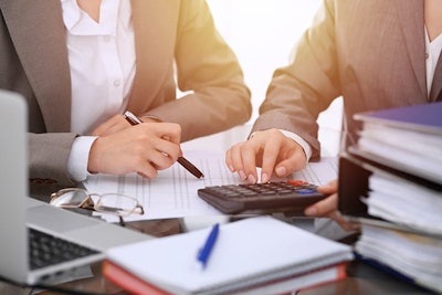 Accountants Using Calculator Adobe Stock Credit Rogerphoto Resized