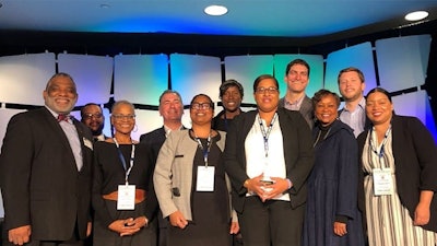 Mass CultivatED founder Chynah Tyler (in white shirt and black blazer) surrounded by representatives from the Urban League of Eastern Massachusetts, Sira Naturals, the Commonwealth Dispensary Association, MedMen, NETA, the Massachusetts Association of Community Colleges, Roxbury Community College and Smith, Costello & Crawford.