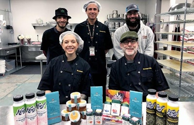 The Buckeye Relief infused-foods team, including Kitchen Manager Emily Rollo (front left), Executive Chef Marc London (front right), Kitchen Tech Lupe Rivera (back row, from left), Kitchen Tech Ricardo Yepez and Assistant Kitchen Manager Ryan Fatica, carefully craft a line of cannabis edibles with a focus on taste and effectiveness.