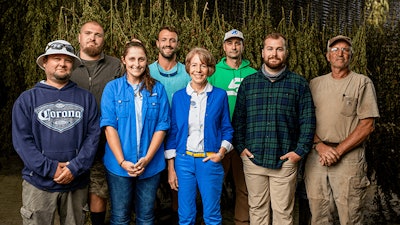 River Organics owner Adrianne Joseph, middle, Operations Manager Ryan Cross, second from right, and team
