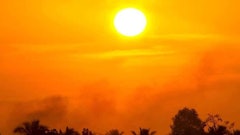 Hot, orange sun swelters landscape