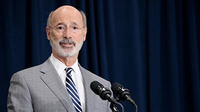 Governor Wolf Speaking Inside With A Blue Curtain In The Background 350
