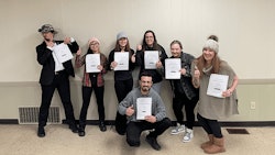 Solar Therapeutics dispensary workers in Somerset, Mass., hold up their negotiated union contract.