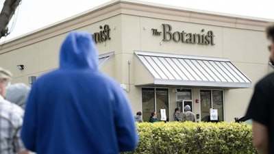 New Jersey adult-use cannabis customers wait in line outside one of Acreage Holdings’ retail facilities ahead of a 10 a.m. opening on April 21.