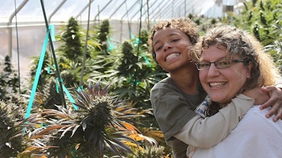 Zaki Jackson, one of the first children who used Charlotte's Web CBD to treat his seizures, with his mother Heather Jackson, co-founder of Realm of Caring