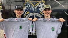 Two retail workers from Green Thumb’s RISE Colorado dispensary in Joliet, Ill., wear hats with the company’s banded logos while they hold up Teamster Local 777 union branded shirts following a vote to unionize in June 2022.