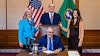 L-R: EAP Program Manager Annette Hoffman, ECY Legislative Coordinator Ken Camp, and WSDA Program Manager Trecia Ehrlich pose with Gov. Jay Inslee (front).