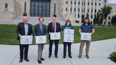 Representatives of New Economic Frontier delivering signatures on July 8.