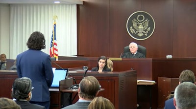 Pro-cannabis rescheduling attorney Matthew Zorn, partner at Yetter Coleman LLP, has an exchange with John J. Mulrooney, the Drug Enforcement Administration's chief administrative law judge, during preliminary proceedings Dec. 2 in Arlington, Va.