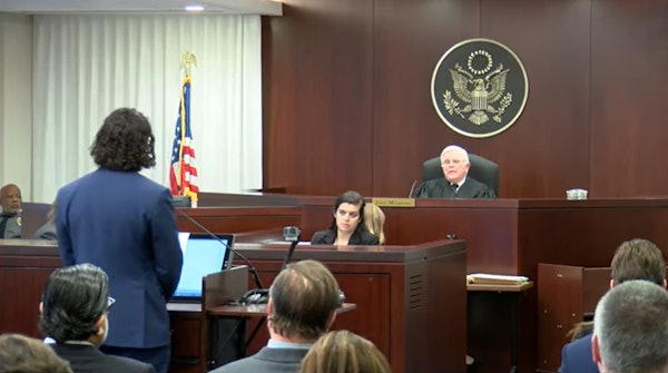 Pro-cannabis rescheduling attorney Matthew Zorn, partner at Yetter Coleman LLP, has an exchange with John J. Mulrooney, the Drug Enforcement Administration's chief administrative law judge, during preliminary proceedings Dec. 2 in Arlington, Va.