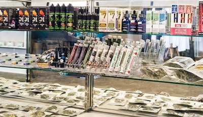 Hemp CBD products in a display case, including tinctures, oils and plant.