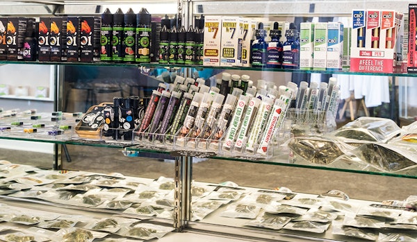 Hemp CBD products in a display case, including tinctures, oils and plant.