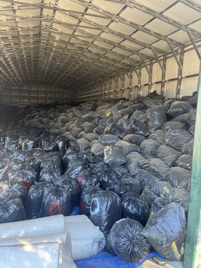 The San Bernardino Marijuana Enforcement Team, County Code Enforcement and California Fish and Wildlife Department seized more than 3,000 trash bags filled with processed cannabis, stacked over 12 feet high, from end to end of the 120-by-40-foot metal building in Oak Hills.