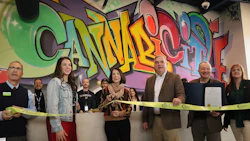 Founder Barbara Vaughn (center left), mayor Gary McCarthy (center right) and supporters cut the ribbon at Cannabicity in Schenectady’s Mohawk Harbor.