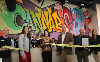 Founder Barbara Vaughn (center left), mayor Gary McCarthy (center right) and supporters cut the ribbon at Cannabicity in Schenectady’s Mohawk Harbor.