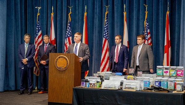 Alabama State Bureau of Investigation Major Crimes Chief Shawn Loughridge (center) talks about a multiagency operation that executed a series of warrants and seizures on June 23 at 10 CBD stores and vape shops in five cities.
