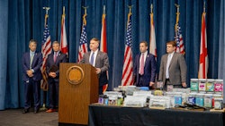 Alabama State Bureau of Investigation Major Crimes Chief Shawn Loughridge (center) talks about a multiagency operation that executed a series of warrants and seizures on June 23 at 10 CBD stores and vape shops in five cities.