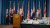 Alabama State Bureau of Investigation Major Crimes Chief Shawn Loughridge (center) talks about a multiagency operation that executed a series of warrants and seizures on June 23 at 10 CBD stores and vape shops in five cities.