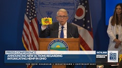 Ohio Gov. Mike DeWine shows how intoxicating hemp products can sometimes be packaged in manners similar to popular candies and snacks that entice children during an Oct. 8 press conference in Columbus.