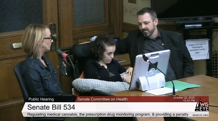Nora Lowe (middle), a 17-year-old with Rett syndrome, testifies in support of a medical cannabis bill on Oct. 22 during the Wisconsin Senate Committee on Health hearing. She's joined by her parents, Megan and Josh.