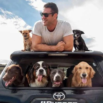 Lee Asher and Lillie with other dogs that are part of the pack at The Asher House. The nonprofit cares for some 150 animals, and through the nonprofit and independently, Asher has rehomed thousands of dogs over the years.