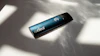 Curalear branded cylindrical device with teal finish and white logo symbol on white surface with shadows