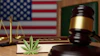 Law office desk with scales of justice, gavel, American flag, and legal documents representing justice and legal practice