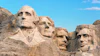 Mount Rushmore monument featuring four carved presidential faces in granite rock against blue sky