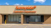 Sunnyside Cannabis Dispensary storefront with orange signage on brick building