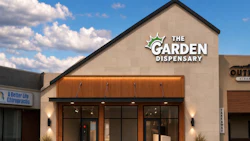 The Garden Dispensary storefront with modern tan facade, wooden accent awning, and glass doors in a retail plaza