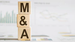 Wooden blocks spelling M&A stacked on business documents with financial charts