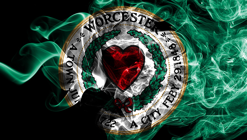 Worcester City Football Club circular emblem with red heart, green wreath, and gold border on black background